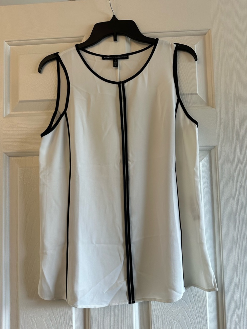White Sleeveless Blouse with Black Trim
